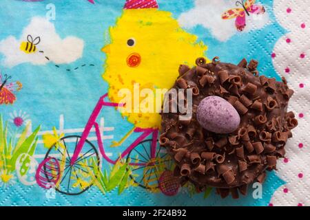 Cadbury Mini Eggs Nest Cake set on Easter serviette napkin Stock Photo