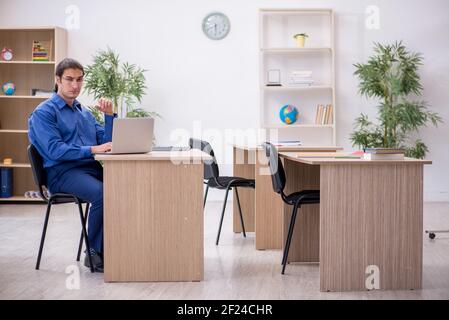 Young male teacher in tele-education concept Stock Photo