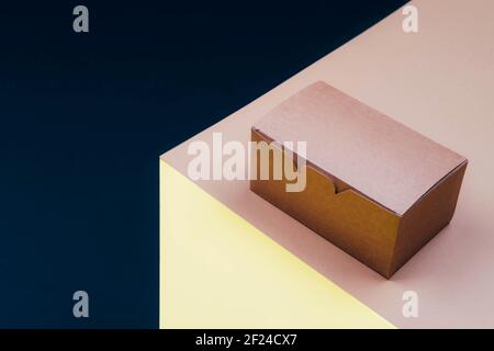 Disposable cardboard container on a platform with space for text.  Stock Photo