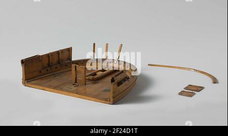Model of a Gun Position on the Afterdeck.Model of the aft deck of a paddle steam ship with a swivel, incomplete. Beschut and upperfuit are missing. The underlay consists of a wooden frame, running over the turning races on bullets in the corners. The rear of the carriage is fixed with hinges on deck and must be folded up to give the slide the option to turn. The model specifically shows the removable backline of the railing, consisting of pieces of pot lid, supports and skin segments. The front part is fixed and has cage beverage. Scale 1:20 (derived). Stock Photo