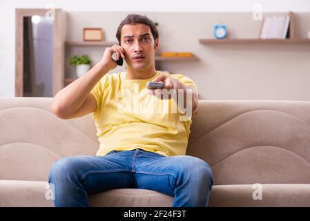 Young man student boring at home during pandemic Stock Photo