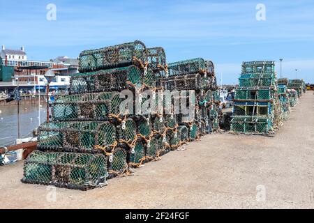 Lobster pots stacked on the quayside in Bridlington, East Yorkshire Stock Photo