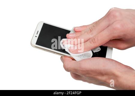 teenage boy cleaning or disinfecting his smart phone with cloth Stock Photo