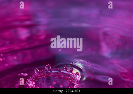 Water drops and ripples on a nice colored background. Amazing natural water background texture. Stock Photo