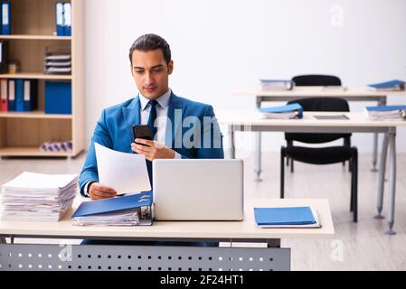 Young businessman employee reading contract in the office Stock Photo