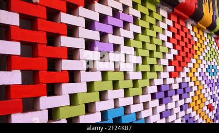 Brick wall painted with very bright colors and retro decoration on a city street. Stock Photo