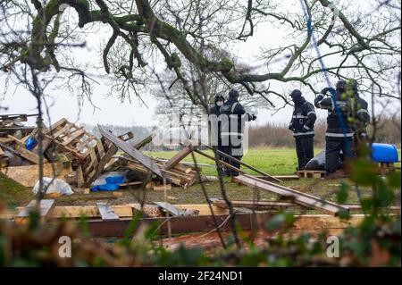 Great Missenden, Buckinghamshire, UK. 10th March, 2021. The NET destroy the camp kitched. Early this morning HS2 Ltd and the National Eviction Team evicted Stop HS2 activists from the Save Leather Lane Protest Camp. HS2 were cutting limbs off the oak trees some of which clearly had potential bat roosts in them as well as destroying hedgerows to put up a high security fence. Locals are furious that HS2 will now fell 14 or more of these much loved beautiful oak trees. The controversial High Speed 2 rail link from London to Birmingham is carving a huge scar across the Chilterns which is an AONB.
