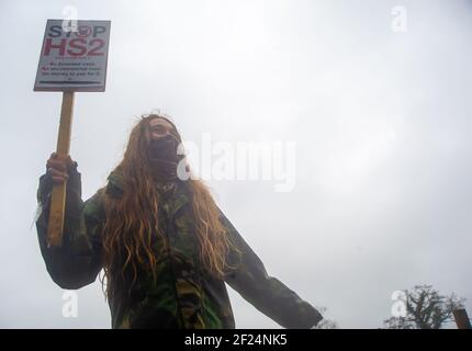 Great Missenden, Buckinghamshire, UK. 10th March, 2021. Early this morning HS2 Ltd and the National Eviction Team evicted Stop HS2 activists from the Save Leather Lane Protest Camp. HS2 were cutting limbs off the oak trees some of which clearly had potential bat roosts in them as well as destroying hedgerows to put up a high security fence. Locals are furious that HS2 will now fell 14 or more of these much loved beautiful oak trees. The controversial High Speed 2 rail link from London to Birmingham is carving a huge scar across the Chilterns which is an AONB. Credit: Maureen McLean/Alamy Live Stock Photo