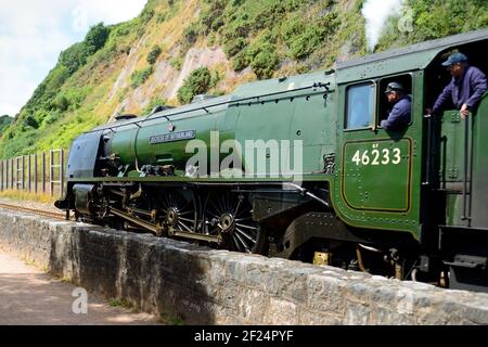 LMS Princess Coronation Class Pacific No 46233 Duchess of Sutherland hauling The Royal Duchy rail-tour along the seawall at Teignmouth 7th August 2016. Stock Photo