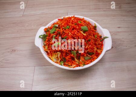 Schezwan fried rice with Schazwan sauce, Chinese fried rice, garnished with spring onions and cabbage. Indian-Chinese dishes; selective focus Stock Photo
