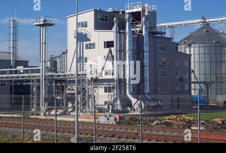 Granary, elevator - an industrial complex for storage, sorting and shipment of grain by rail. Agro-processing and manufacturing plant. Agricultural co Stock Photo