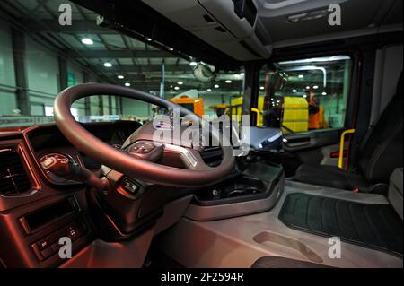 Interior of a new model of a dump truck Scania cabin: seat, wheel, dashboard Stock Photo