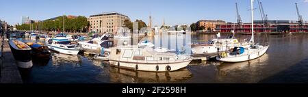 A panoramic view of evening light on the harbourside at Bristol Docks, UK - The Arnolfini Gallery and St Marys Redcliffe church are across the water. Stock Photo