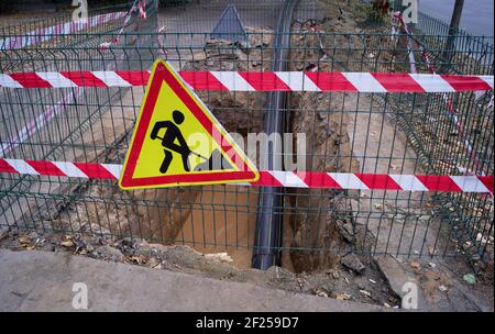 Repair of the underground pipeline. Laying a plastic pipe underground by tightening Stock Photo