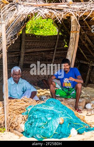 HIKKADUWA, SRI LANKA - JANUARY 22, 2014: Unidentified fishermen at Hikkaduwa in Sri Lanka. At 2013 there were around 220.000 marine fishers in Sri Lan Stock Photo