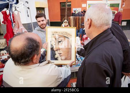 People looking at picture, Seville's oldest street market, Mercadillo de los Jueves, Thursday market, , Seville, Andalusia, Spain Stock Photo