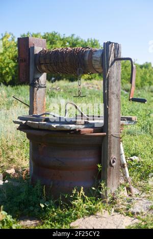 Modern Rustic Wooden Water Extraction Well Rusty Chain Stock Photo