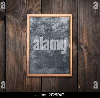 Rectangular brown wooden frame on a background of very old boards Stock Photo