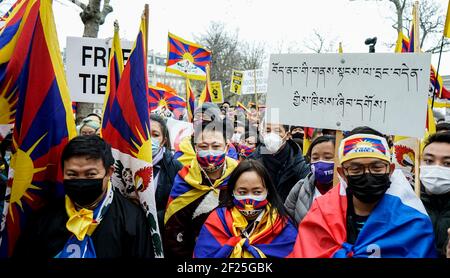 Thousands of Tibetans and supporters protest on the streets of Trocadero square near the famous Eiffel Tower in Paris to commemorate the 62th anniversary of the Tibetan National Uprising Day. A street play was organised on the recent death of Tenzin Nyima, a 19 year old Tibetan monk due to torture in Chinese prison. Stock Photo