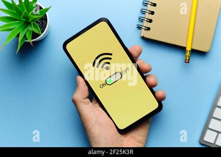 Wi-Fi mode enabled concept with smartphone in person hand.