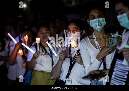Supporters and employees of ABS-CBN, the country's largest broadcast network, light candles and shout slogans as they join a protest in front of the ABS-CBN building in Manila, Philippines. Stock Photo