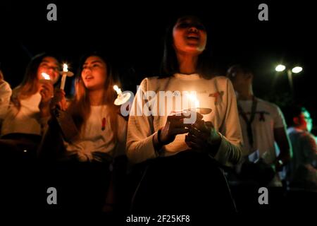Supporters and employees of ABS-CBN, the country's largest broadcast network, light candles and shout slogans as they join a protest in front of the ABS-CBN building in Manila, Philippines. Stock Photo