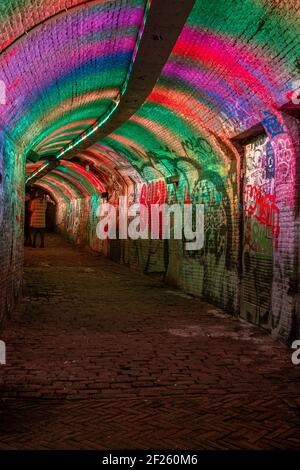 Colorful green, blue, pink illuminated Ganzemarkt tunnel in the centre of Utrecht, The Netherlands Stock Photo