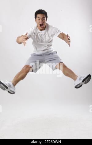 A young man jumping in casual clothes Stock Photo