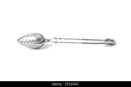 Metal vintage tea strainer in a cup isolated on white background Stock Photo