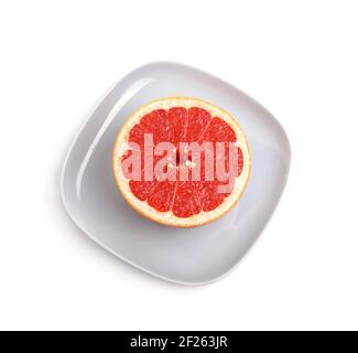 Ripe red grapefruit. The cut fruit on a blue plate Stock Photo