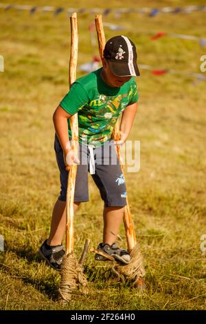 Russia. Vyborg. 08.20.2020 a young boy walks on stilts in the summer in nature Stock Photo