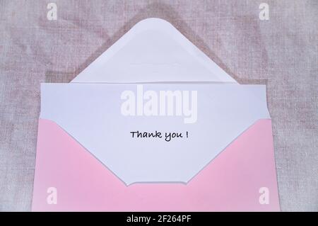 A Thank You note in a pink envelope Stock Photo