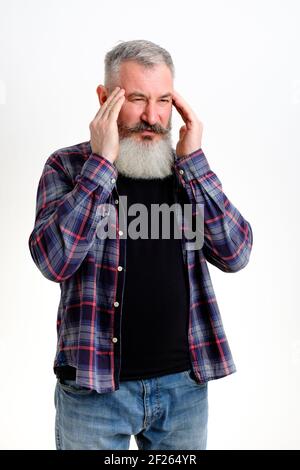 Mature man dressed in casual clothes feels bad, headache and overworking, negative emotions, stressed, white background Stock Photo