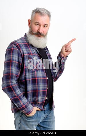 Studio portrait mature man dressed in casual clothes points aside, I choose this, white backdrop Stock Photo