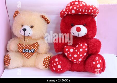 Lovely red teddy bear with red heart on white background Stock Photo