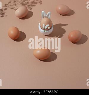 2021 Easter composition with  natural eggs decorated with wild flowers  over pastel  beige  background. Minimal sunlight  flat lay. Holiday concept. Stock Photo
