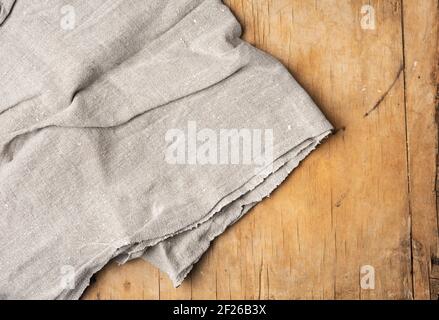 Gray kitchen towel on brown wooden background, Stock Photo