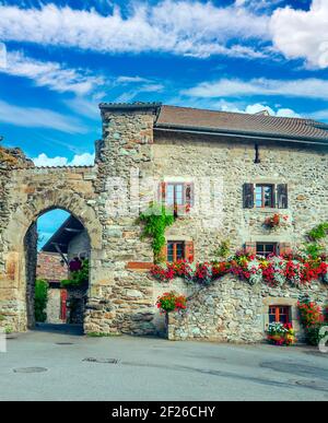 Facade with windows and flowers in Yvoire in France Stock Photo