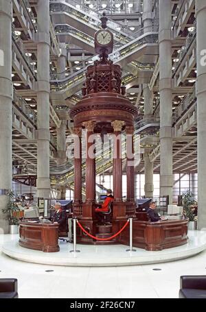 Historical 1996 interior archive view of the Lutine Bell housed in the Rostrum with surroundings of the radical modern Bowellism architecture designed by architect Richard Rogers for Lloyds the location of the famous insurance and reinsurance market business in a Grade I listed building located in Lime Street in the financial district of the City of London a1990s archival image of the way we were England UK in the 90s Stock Photo