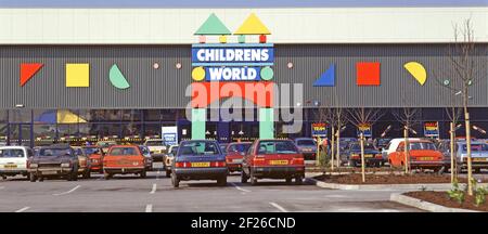 Historical 1987 archive shopping image of customers cars parked outside Childrens World a British retail business chain store founded by Boots in 1980s using a decorated superstore warehouse type shop building selling kids clothes shoes toys baby products & nursery furniture located in a retail park at Thurrock illustrating an archival view of the way we were at Christmas time in 80s Essex England UK Stock Photo