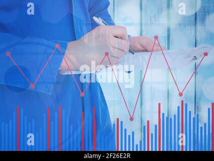 Statistical data processing over mid section of woman taking notes against wooden background Stock Photo