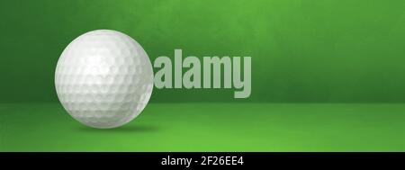 White golf ball on a green studio banner Stock Photo