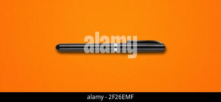 Black felt pen isolated on orange banner Stock Photo