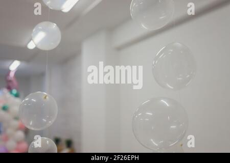 White And Transparent Balloons On Brick Wall Background Stock Photo