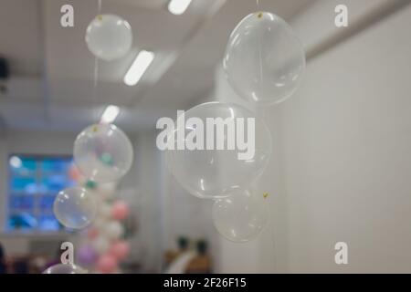 White And Transparent Balloons On Brick Wall Background Stock Photo