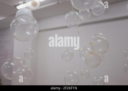 White And Transparent Balloons On Brick Wall Background Stock Photo