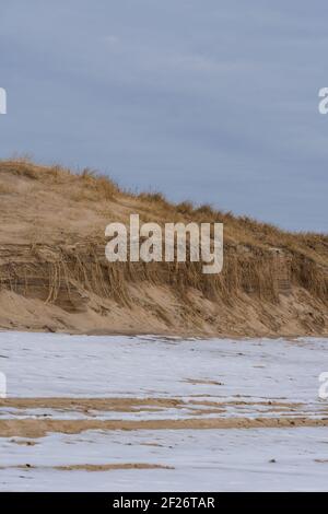 The sand dunes in Montauk with a snow covering the sand Stock Photo