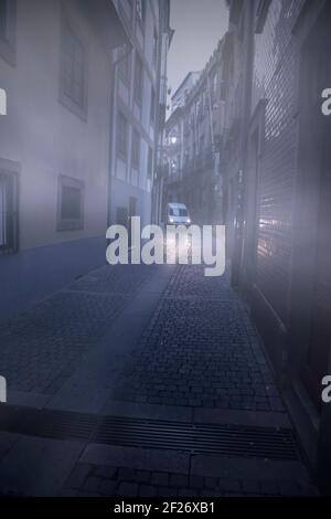 Old Porto foggy narrow street at dawn Stock Photo