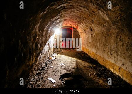 Tunnel with concrete walls in old abandoned Soviet bunker. Stock Photo