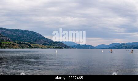 PENTICTON, CANADA - JULY 3, 2020: recreation time paddle boarding on scenic peaceful mountain lake. Stock Photo